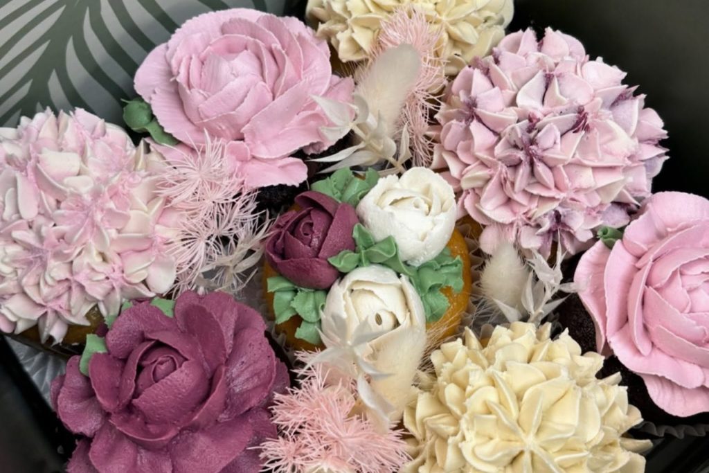 Buttercream flower cupcakes piped like roses and hydrangeas by JJ Bakes